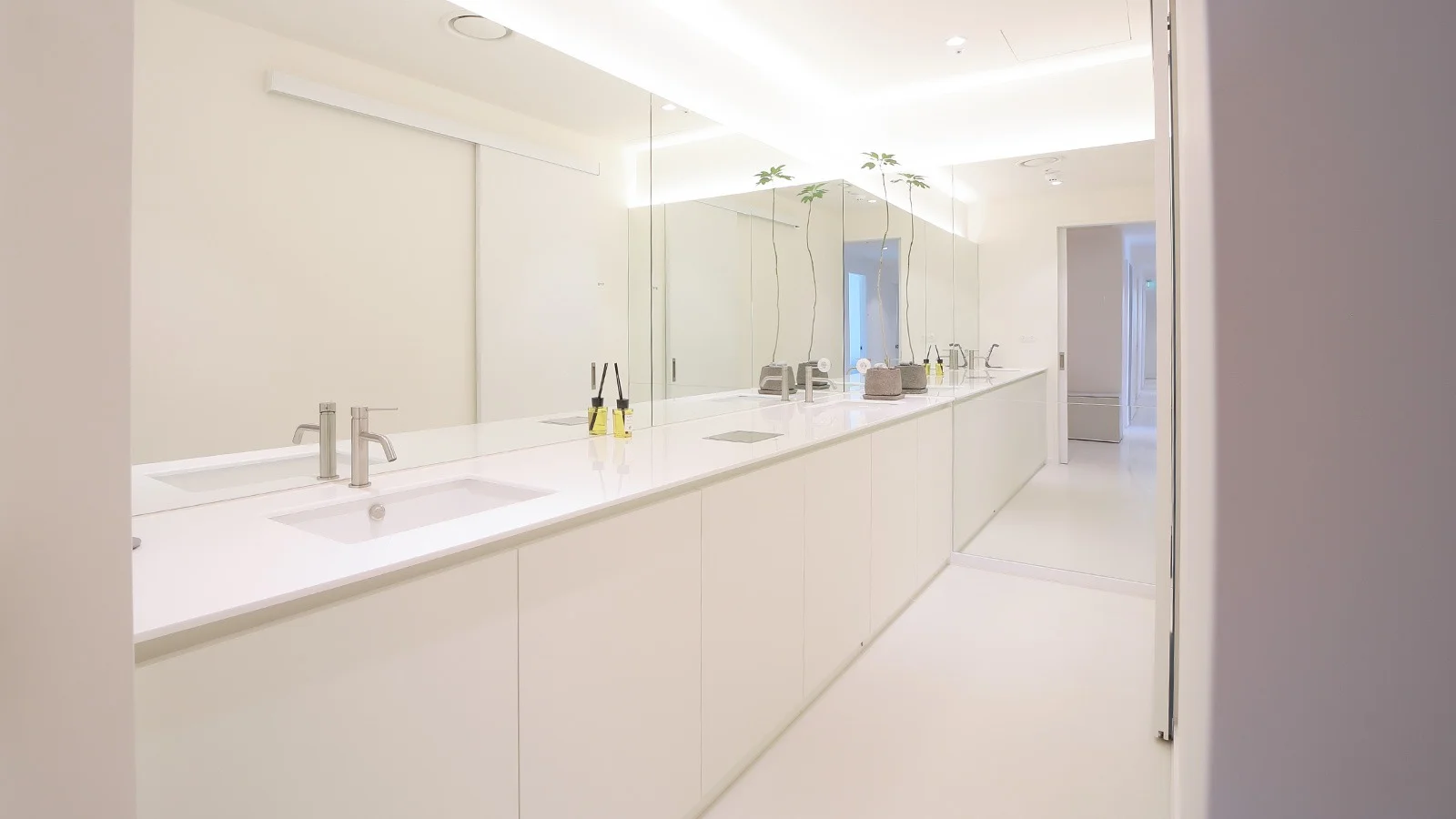 Modern bathroom with long counter and sinks for plastic surgery. 345 Plastic Surgery where natural.