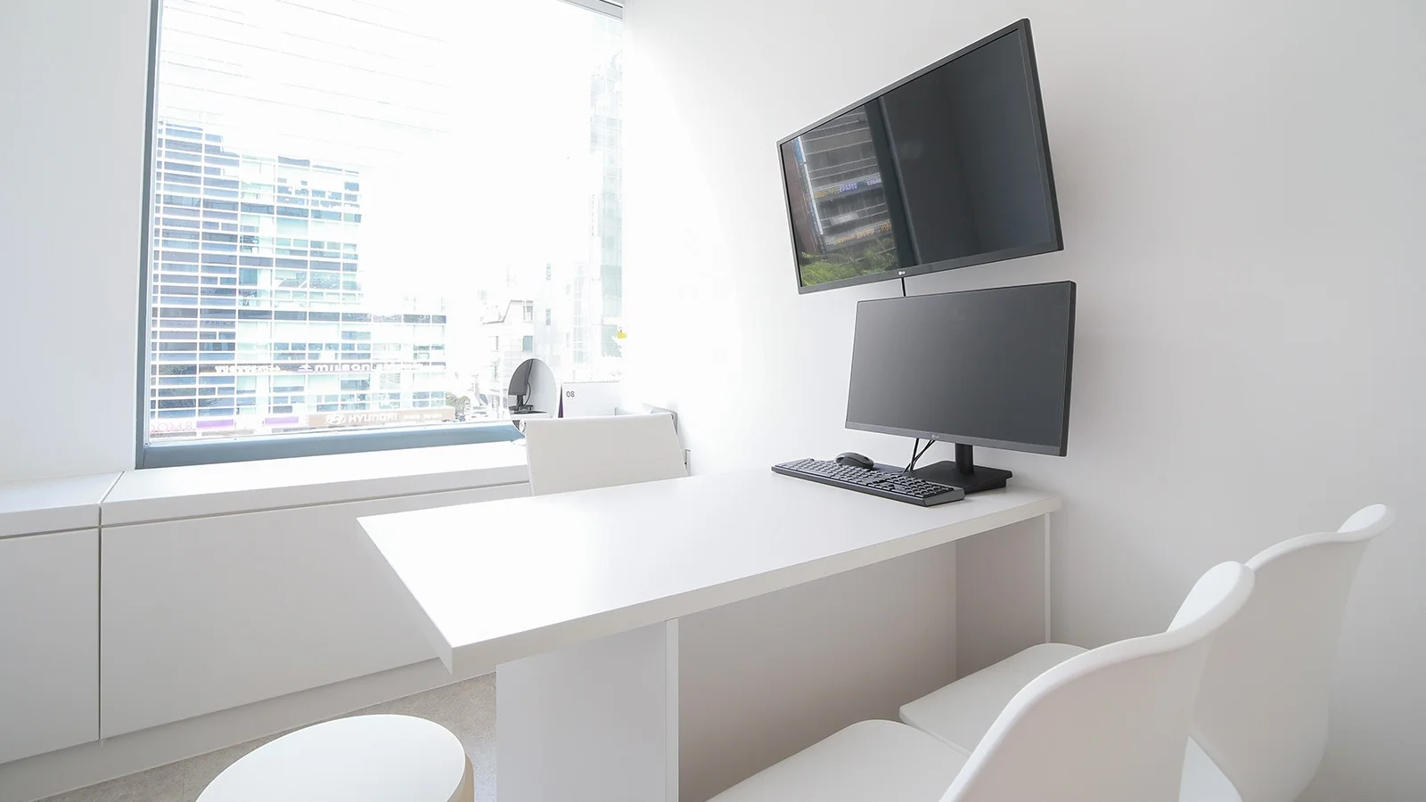 345 Plastic Surgery office with computer for natural results. Modern white aesthetic.