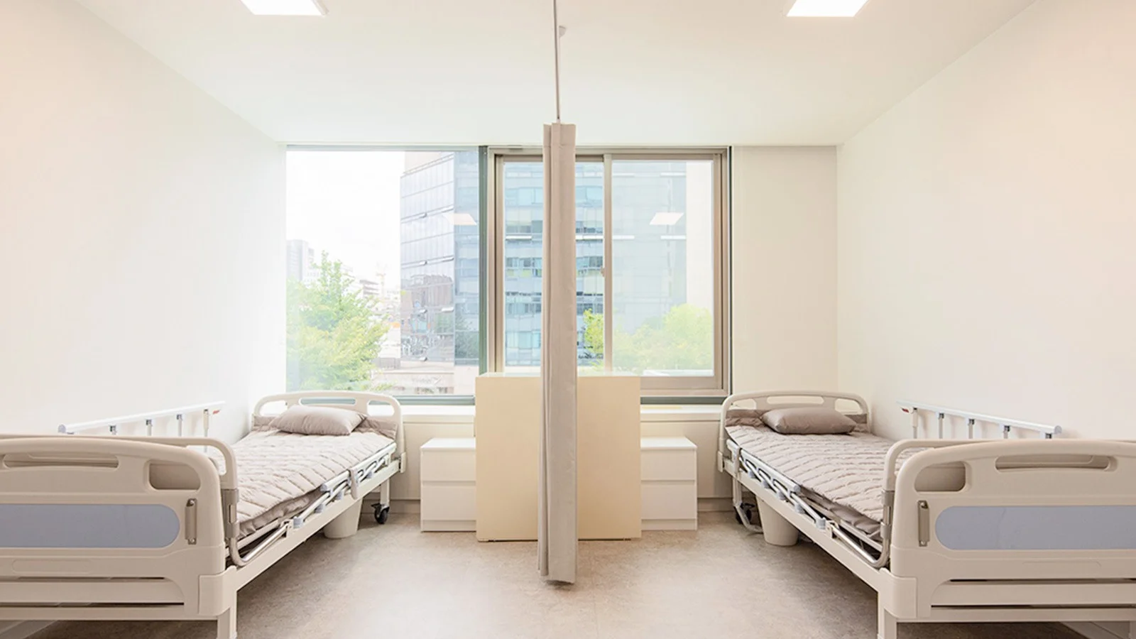 Hospital room interior for 345 Plastic Surgery where natural recovery. Beds for plastic surgery patients.