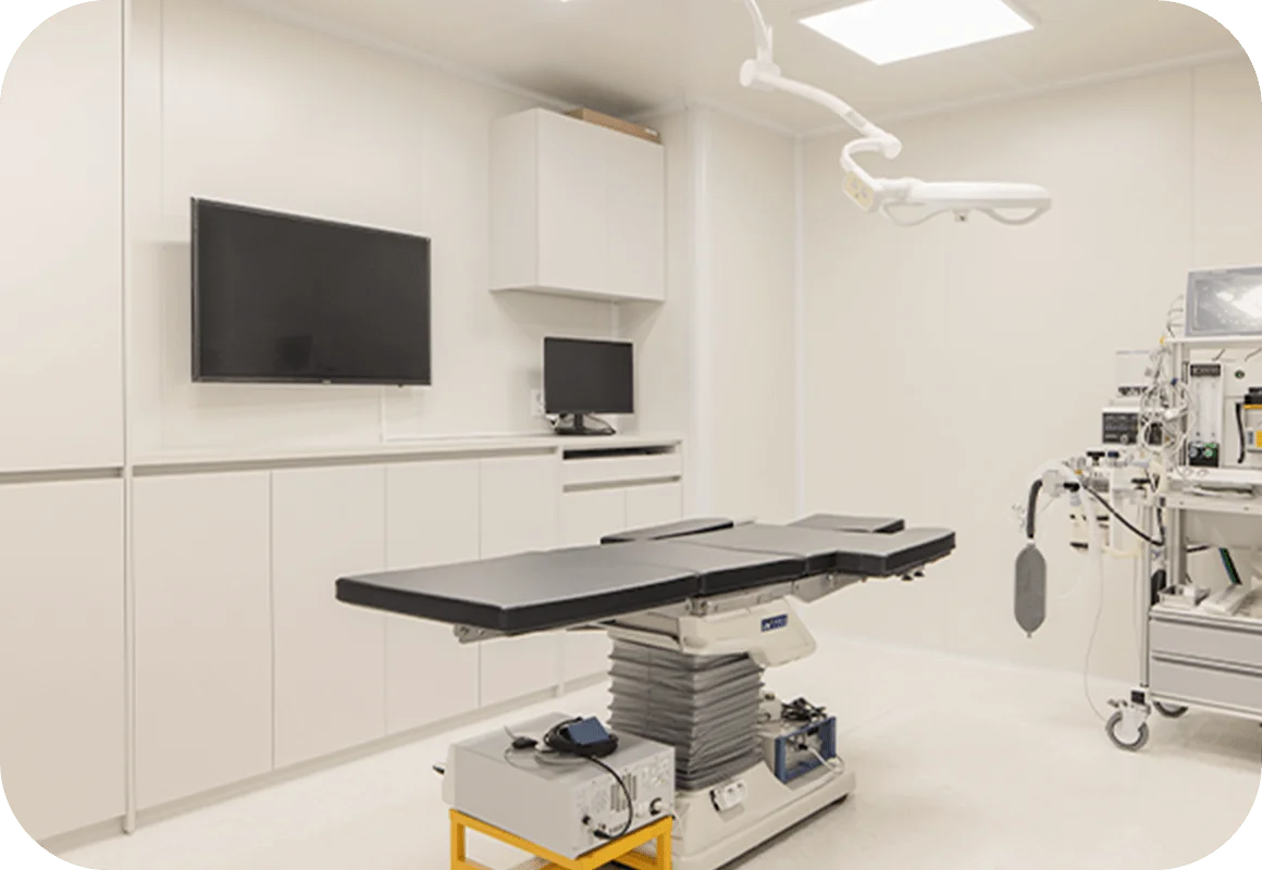 Surgical suite for 345 Plastic Surgery where natural results are achieved. Operating room with surgical table and medical equipment.