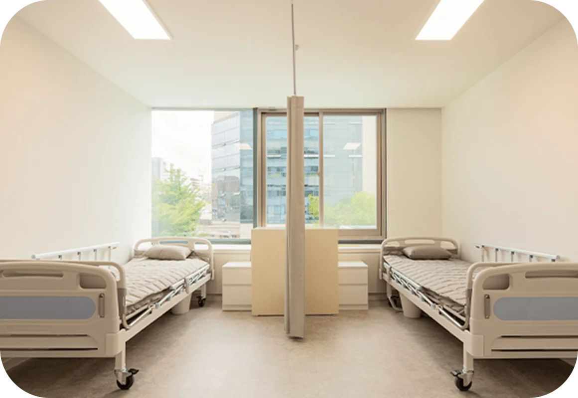 Hospital room with two beds for 345 Plastic Surgery where natural recovery.