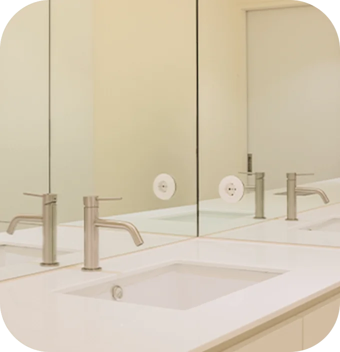 Bathroom sink and mirror reflecting faucets. 345 Plastic Surgery where natural results enhance beauty.