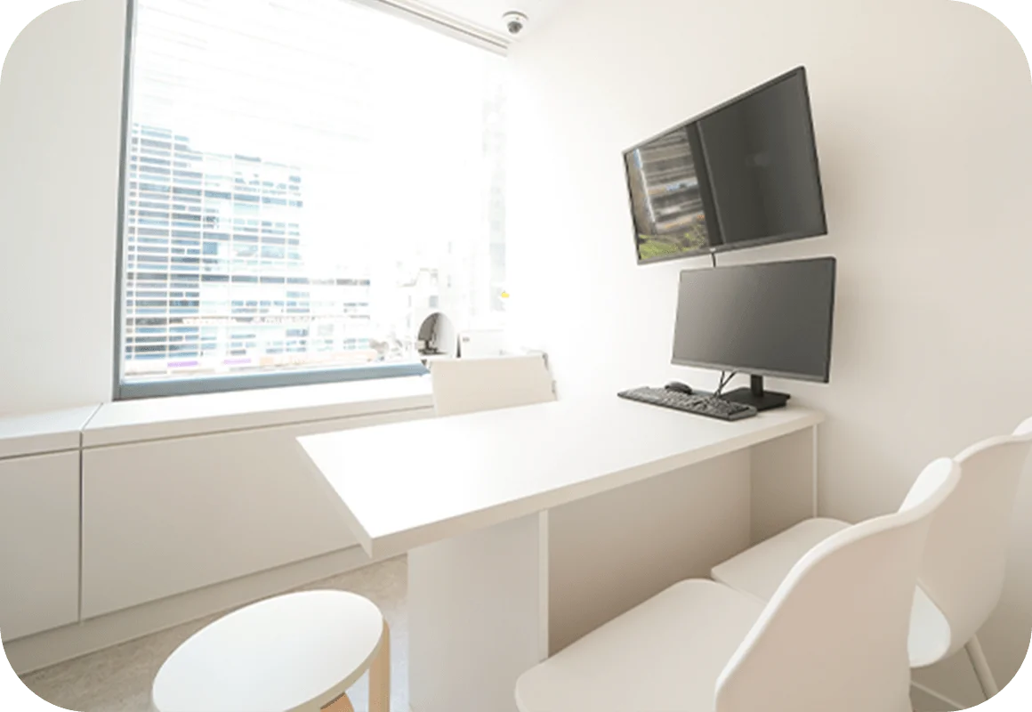 Modern office interior for 345 plastic surgery where natural procedures. Desk, chairs, and computer setup.