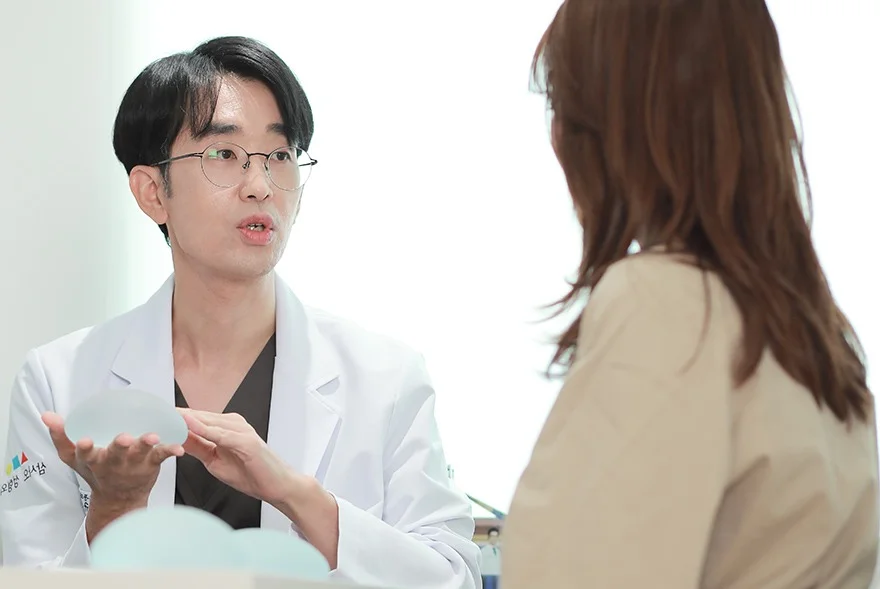 Doctor discusses breast implants with patient.
